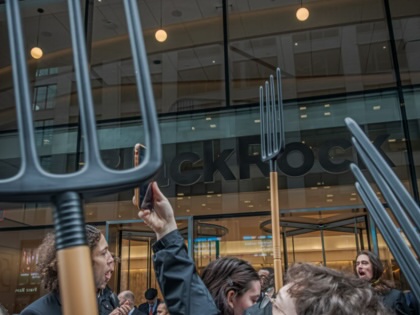 Protesters wield pitchforks outside of BlackRock headquarters in Manhattan on April 28, 2023.