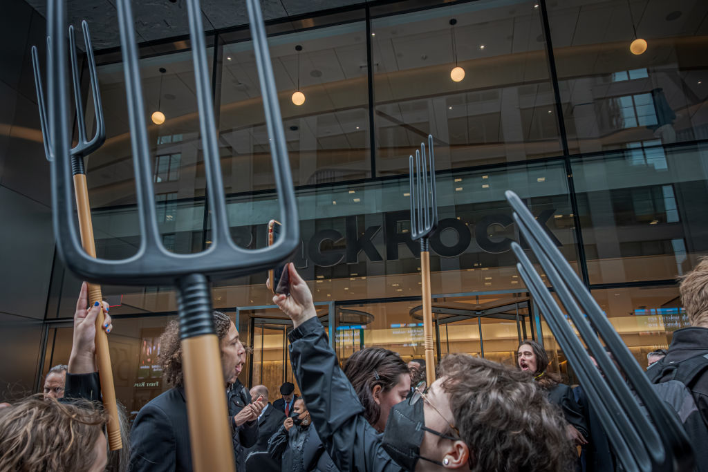 Protesters wield pitchforks outside of BlackRock headquarters in Manhattan on April 28, 2023.