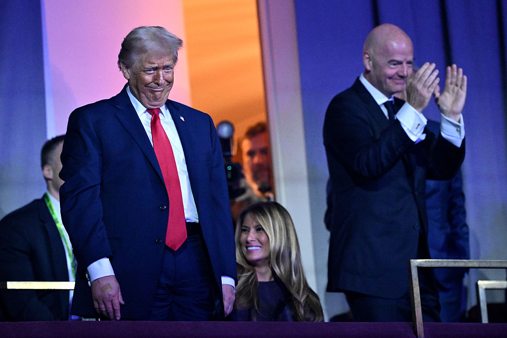 Donald Trump, Melania Trump, and Gianni Infantino react during the FIFA World Cup 2026 Official Draw at the Kennedy Center on December 5, 2025, in Washington, DC. 