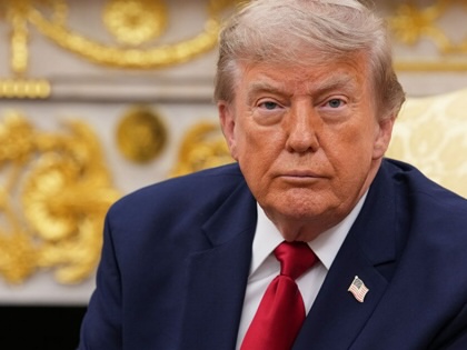 Donald Trump looks toward the camera in the Oval Office.
