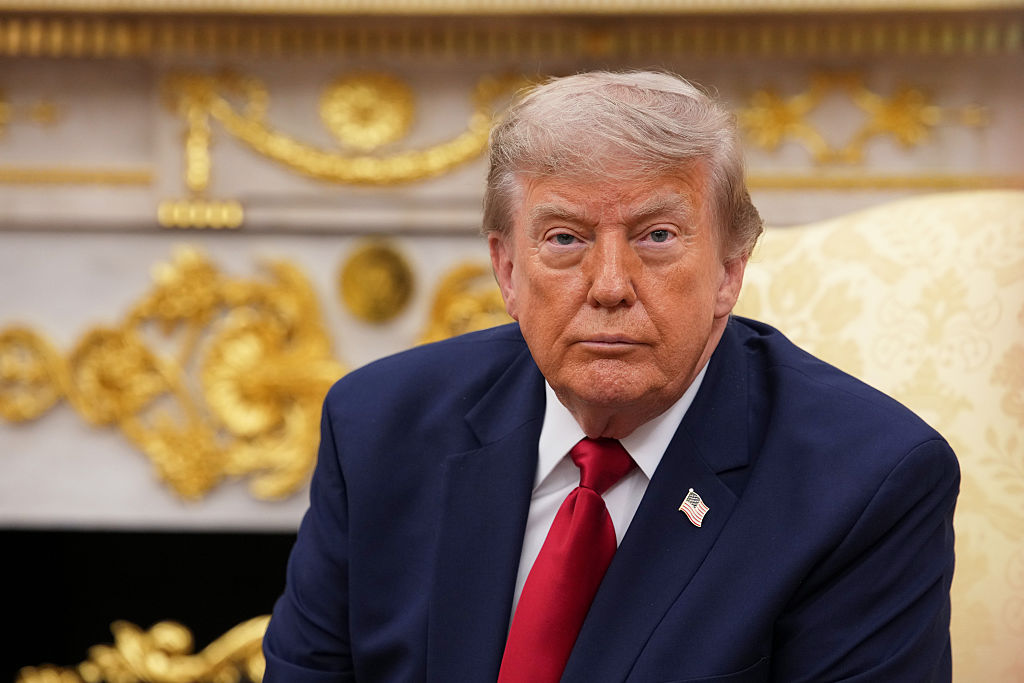 Donald Trump looks toward the camera in the Oval Office.