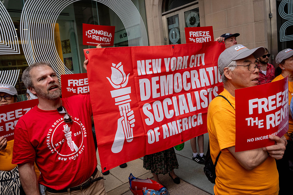 Demonstrators hold a "Democratic Socialists of America" banner ahead of a vote by the Rent Guidelines Board at El Museo del Barrio in New York, US, on Thursday, June 25, 2026.