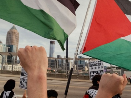 Demonstrators wave Palestinian flags during a Gaza solidarity rally at the 17th Street Bridge in Atlanta, Georgia, on October 4, 2025.