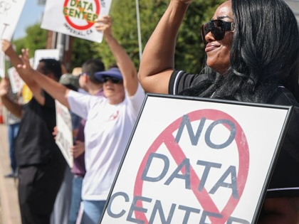 Protesters wave signs during a nationwide protest against AI data center expansion in Imperial, California, on July 18, 2026.