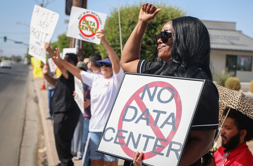Protesters wave signs during a nationwide protest against AI data center expansion in Imperial, California, on July 18, 2026.