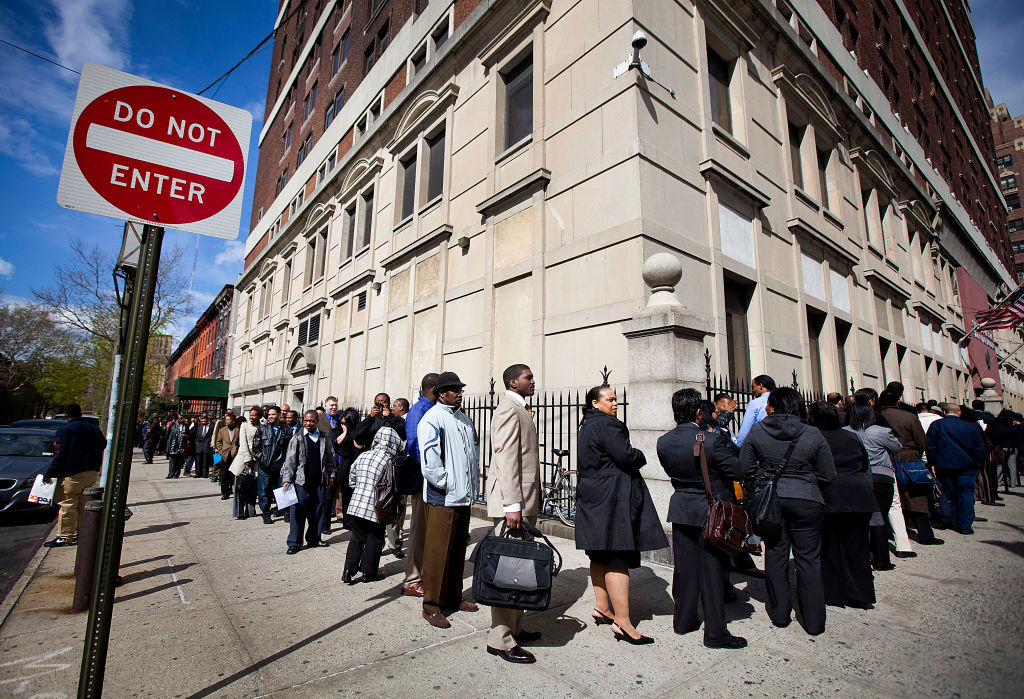 Job seekers wait in line to enter the Dr King career fair in Brooklyn on April 12, 2012.