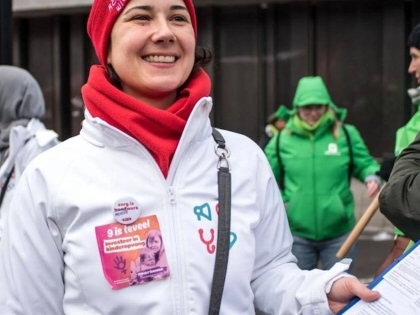 An activist from Medics for the People collects signatures.