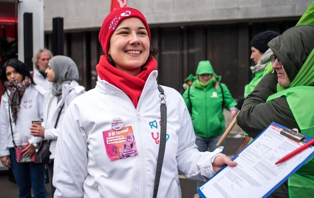 An activist from Medics for the People collects signatures.