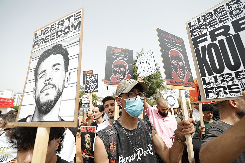 Protesters hold placards in support of Moroccan rapper El Mehdi Lyoubi, known professionally as Mehdi Black Wind, in front of the Ain Sebaa Court of First Instance where Lyoubi was appearing for a court hearing, in Casablanca on July 22, 2026.