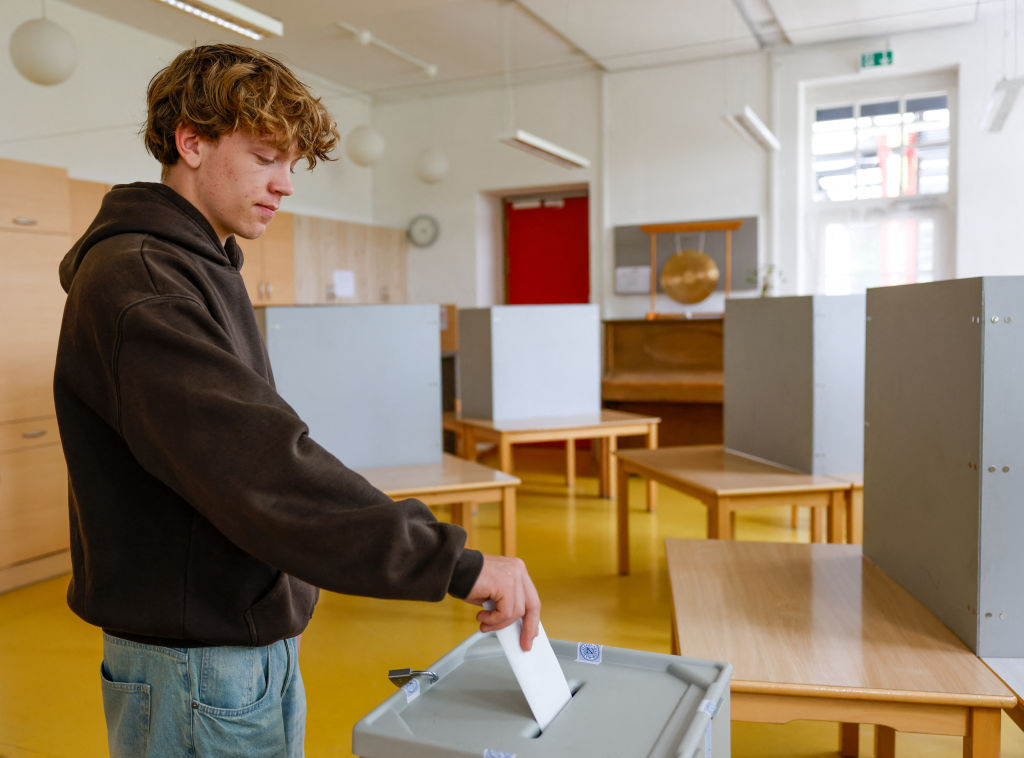 A German sixteen-year-old casts his vote for European Parliament in a 2024 election.