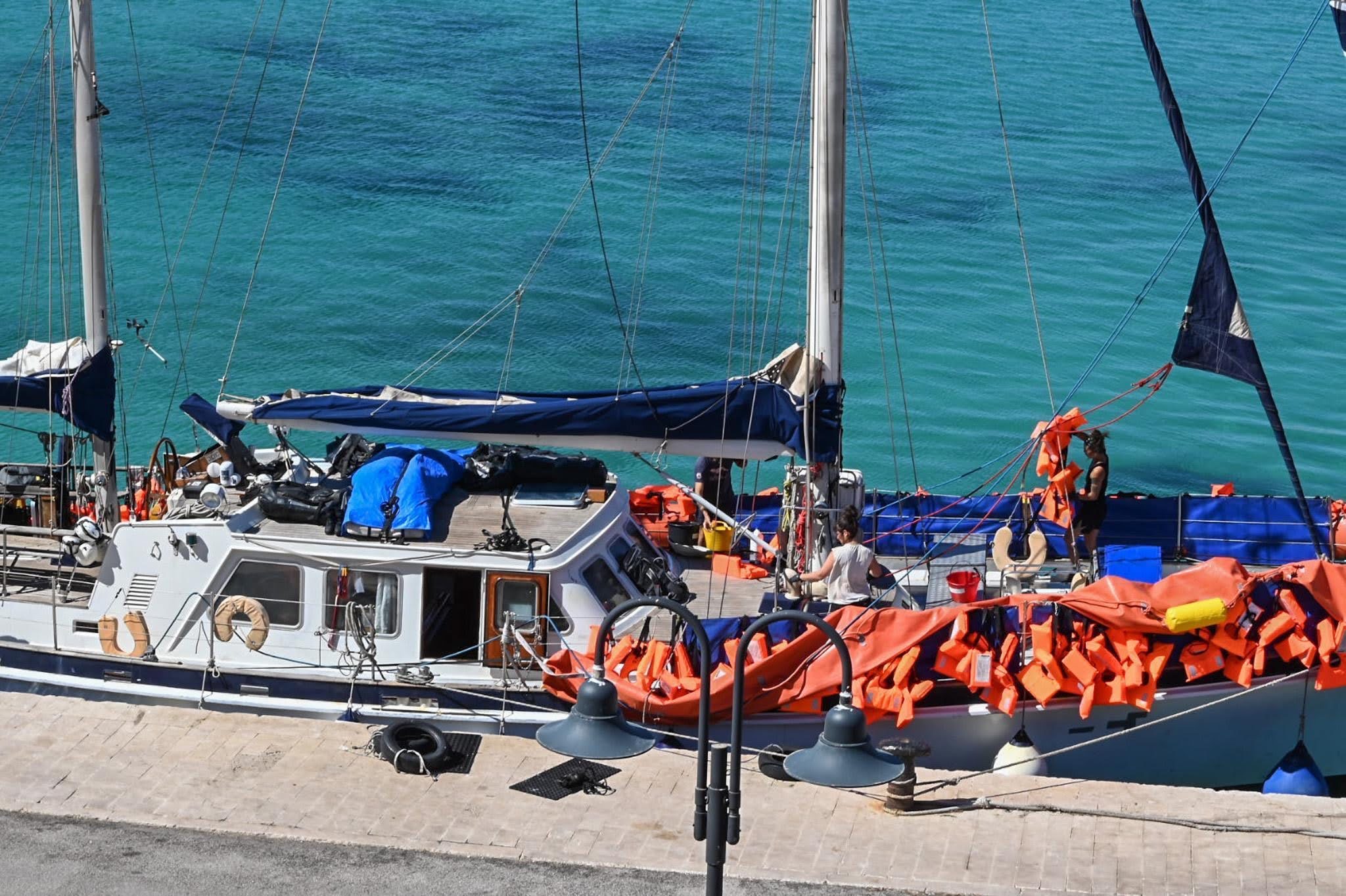 The crew of the rescue vessel Nadir clean the ship following a rescue. 