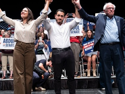 (L-R) U.S. Rep. Alexandria Ocasio-Cortez (D-NY), Michigan Democratic candidate for Senate Abdul El-Sayed and U.S. Sen. Bernie Sanders (I-VT) greet the crowd after El-Sayed spoke at The People V. The Powerful rally at the Detroit Opera House on July 18, 2026, in Detroit, Michigan.