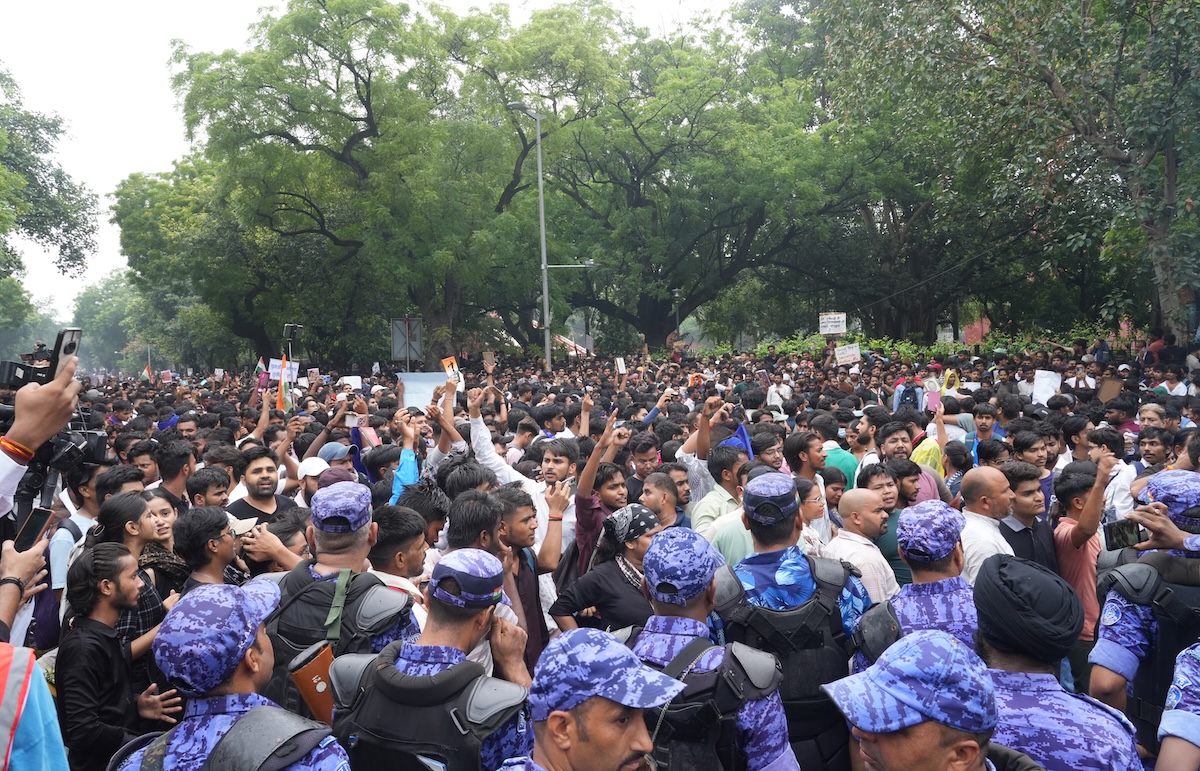 Police and protesters gather before a march to Parliament.