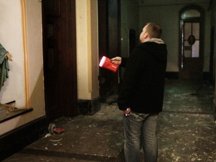 A Dublin City Council worker shines a torch in the corridor of the now derelict Sisters of Our Lady of Charity Magdalene Laundry on Sean McDermott St in Dublin’s north inner city on May 2, 2013.