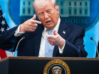 Donald Trump mimics firing a gun during a news conference in the White House briefing room about the war in Iran on April 6, 2026.