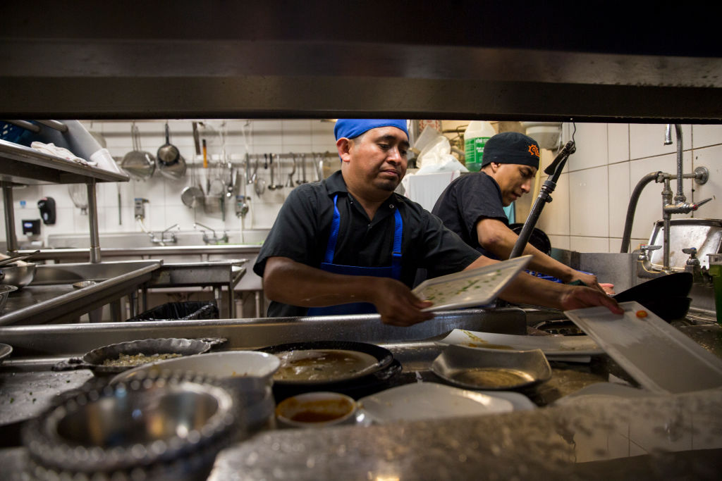 Dishwashers Esteban Soc, left, and Joselino Aguilar, right, at work in the kitchen of Mexican restaurant Caracol in Houston, Texas, on July 12, 2017.
