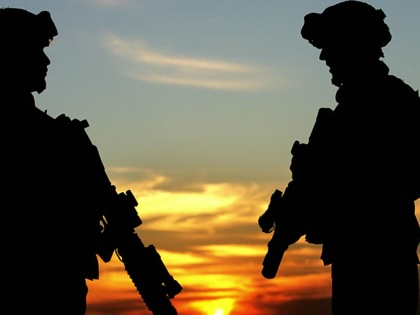 US soldiers are photographed standing at a hill overlooking the Iraqi northern city of Kirkuk on December 11, 2005.