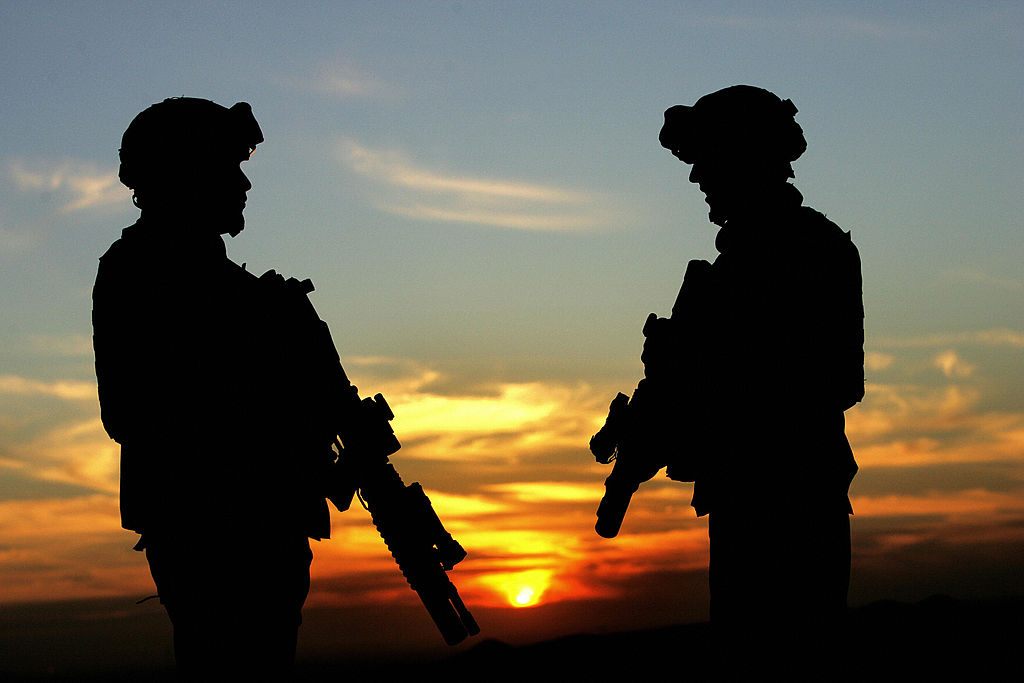 US soldiers are photographed standing at a hill overlooking the Iraqi northern city of Kirkuk on December 11, 2005.