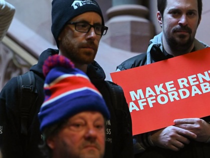 People hold signs as tenant advocates and lawmakers hold a rally at the New York State Capitol to unveil a Make Rent Affordable platform in Albany, New York, on January 27, 2026.