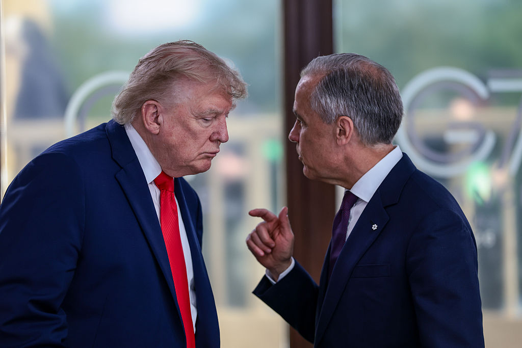 Donald Trump speaks with Mark Carney at a working lunch with leaders of G7 on June 16, 2026, in Évian-les-Bains, France.
