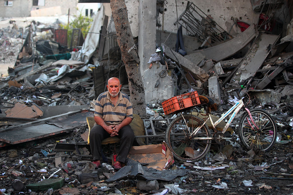 A Palestinian man rests amid debris at the site of an Israeli strike on a house in Gaza City, on July 30, 2026.