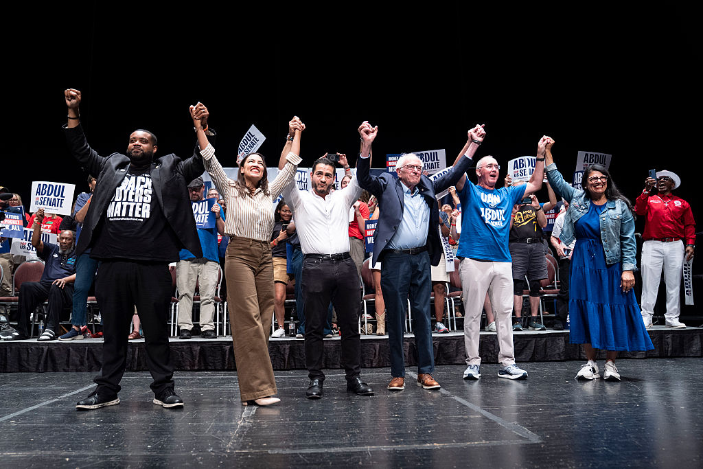 Michigan State Rep. Donavan McKinney, U.S. Rep. Alexandria Ocasio-Cortez (D-NY), Michigan Democratic candidate for Senate Abdul El-Sayed, U.S. Sen. Bernie Sanders (I-VT), U.A.W. President Shawn Fain and Congresswoman Rashida Tlaib greet the crowd after El-Sayed spoke at The People V. The Powerful rally at the Detroit Opera House on July 18, 2026 in Detroit, Michigan. Sanders, Ocasio-Cortez and others joined El-Sayed to rally the crowds.