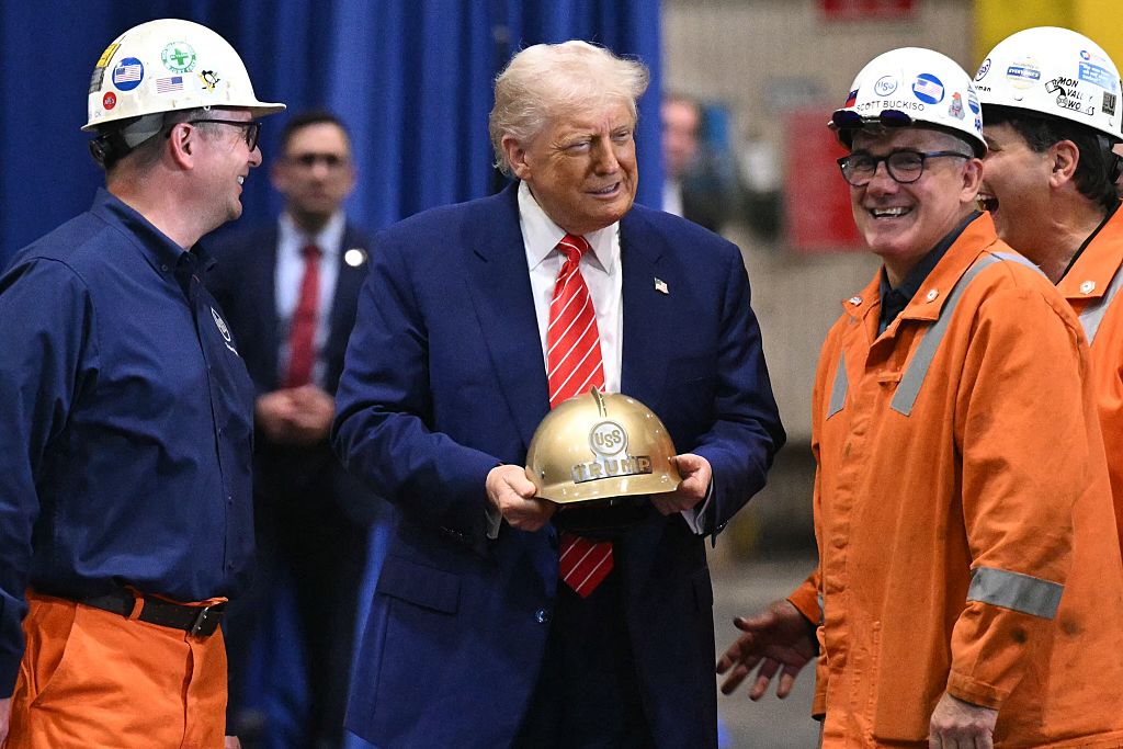 Donald Trump receives a gold helmet with his name on it during a visit to US Steel - Irvin Works in West Mifflin, Pennsylvania, on May 30, 2025, to mark the deal between Nippon Steel and US Steel.