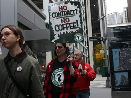 Starbucks baristas gather outside a Starbucks store as they protest against the company during a rally to demand a new contract in New York City on October 28, 2025.