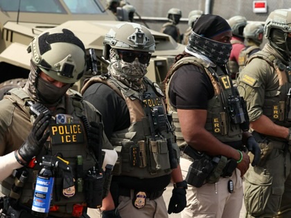 ICE agents stand guard as protesters gather at Delaney Hall in Newark, New Jersey, on May 26, 2026. 