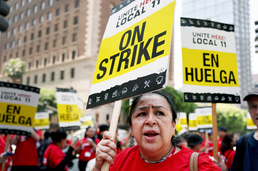 Hotel workers with Unite Here Local 11 picket outside the InterContinental hotel on the first day of a strike by union members at many major hotels in Southern California on July 2, 2023, in Los Angeles, California.