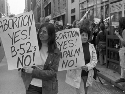 Two women protesters hold up signs against state abortion regulations on May 6, 1972, in New York City.