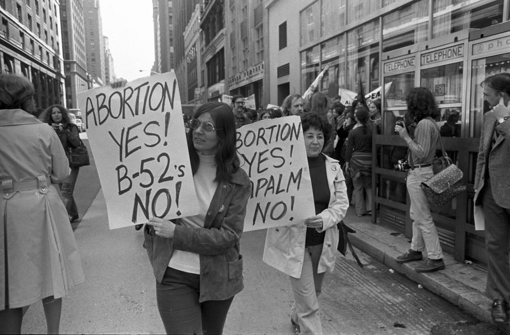 Two women protesters hold up signs against state abortion regulations on May 6, 1972, in New York City.