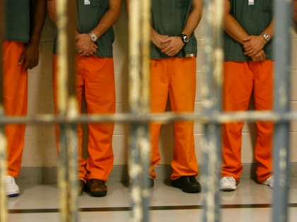 Inmates wait in line to be escorted to their cells at the Brazoria County Sheriff Department and Detention Center II in Angleton, Texas, May 5, 2006.