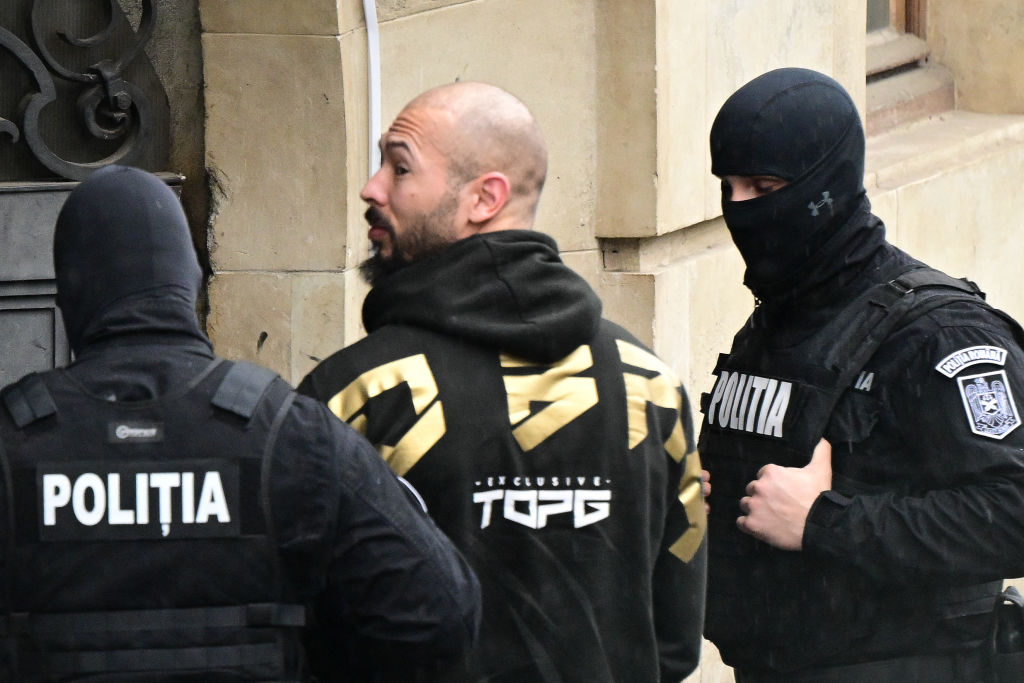 Andrew Tate is led by police officers into the Court of Appeal building in Bucharest, Romania, on March 12, 2024.