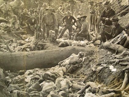 US soldiers pose with massacred Moro people at Bud Dajo in the Philippines, 1906.