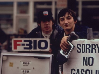 Gas station attendants peer over their "Out of gas" sign in Portland, one day before the state's requested Saturday closure of gasoline stations in 1973.