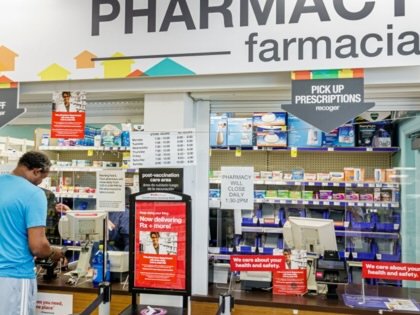 A man at a pharmacy counter.
