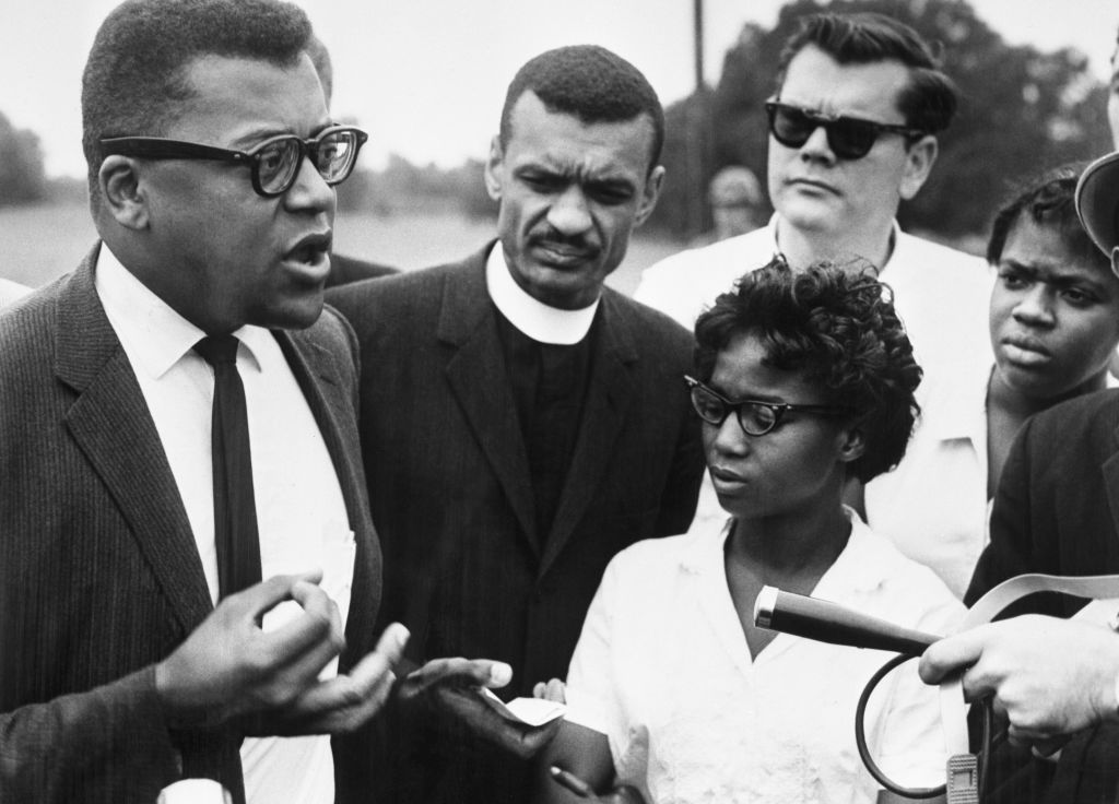 James Lawson (left), a spokesperson for the Freedom Riders, holds an impromptu press conference in Alabama just before the bus carrying the integration group crossed the state line into Mississippi.
