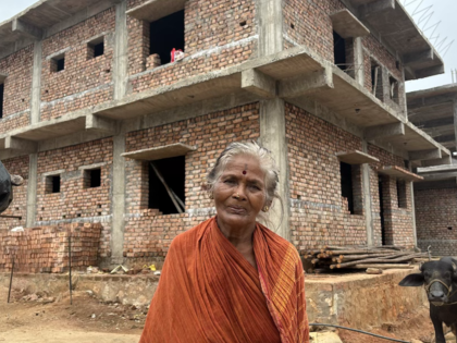 P. Bangarama outside the house her family is constructing with compensation received after the acquisition of their farmland for Google’s proposed hyperscale data center in Tarluvada, Andhra Pradesh.