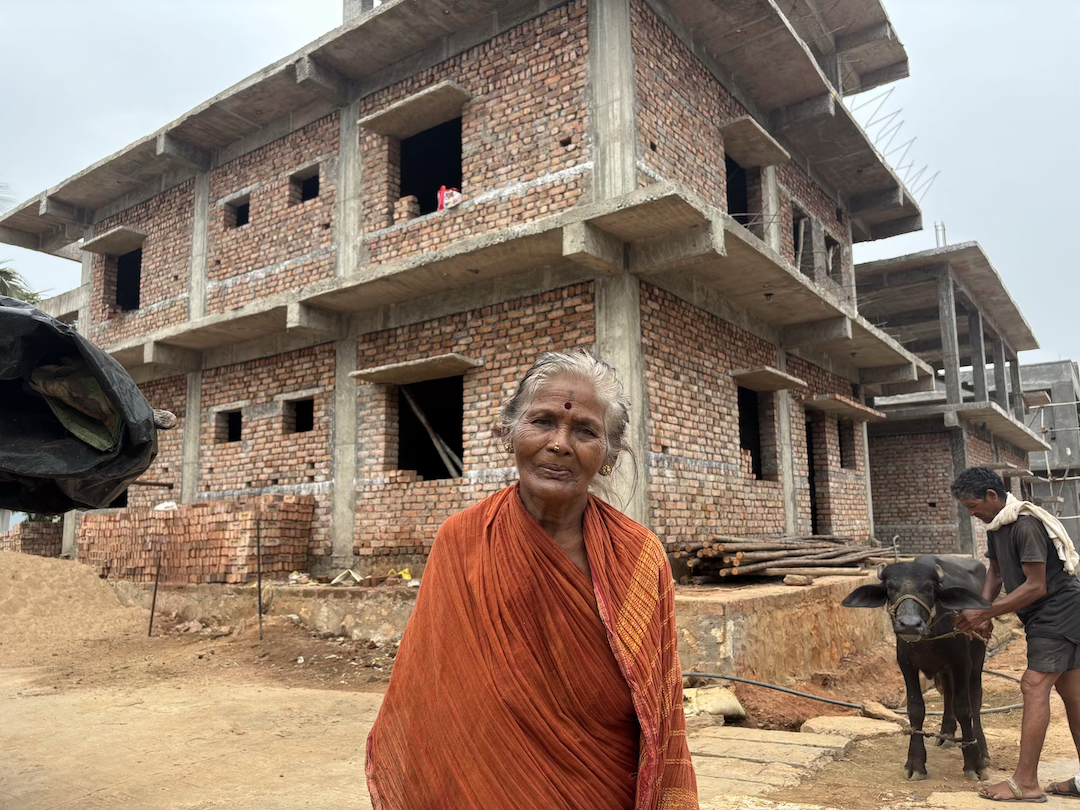 P. Bangarama outside the house her family is constructing with compensation received after the acquisition of their farmland for Google’s proposed hyperscale data center in Tarluvada, Andhra Pradesh.