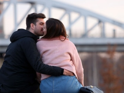 A couple kisses in a park in Berlin, Germany on March 11, 2018.