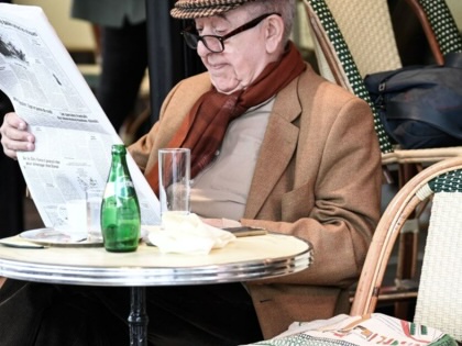 A man reads a newspaper on the terrace of Paris's landmark Café de Flore on May 19, 2021.