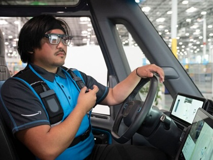 An Amazon delivery driver wears smart glasses displaying real-time navigation and delivery instructions directly in his field of vision, during Amazon's "Delivering the Future" presentation in Milpitas, California on October 22, 2025. 