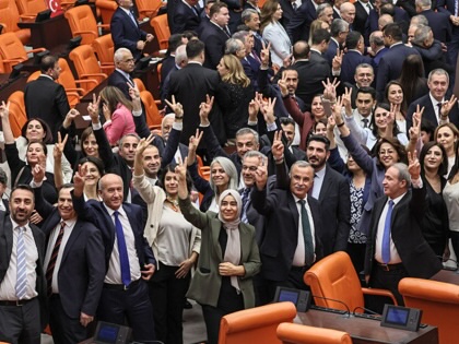 Equality and Democracy (DEM) Party lawmakers make the victory sign after voting for a bill offering limited amnesty for Kurdish PKK militants at the Grand National Assembly of Turkey in Ankara on August 10, 2026.