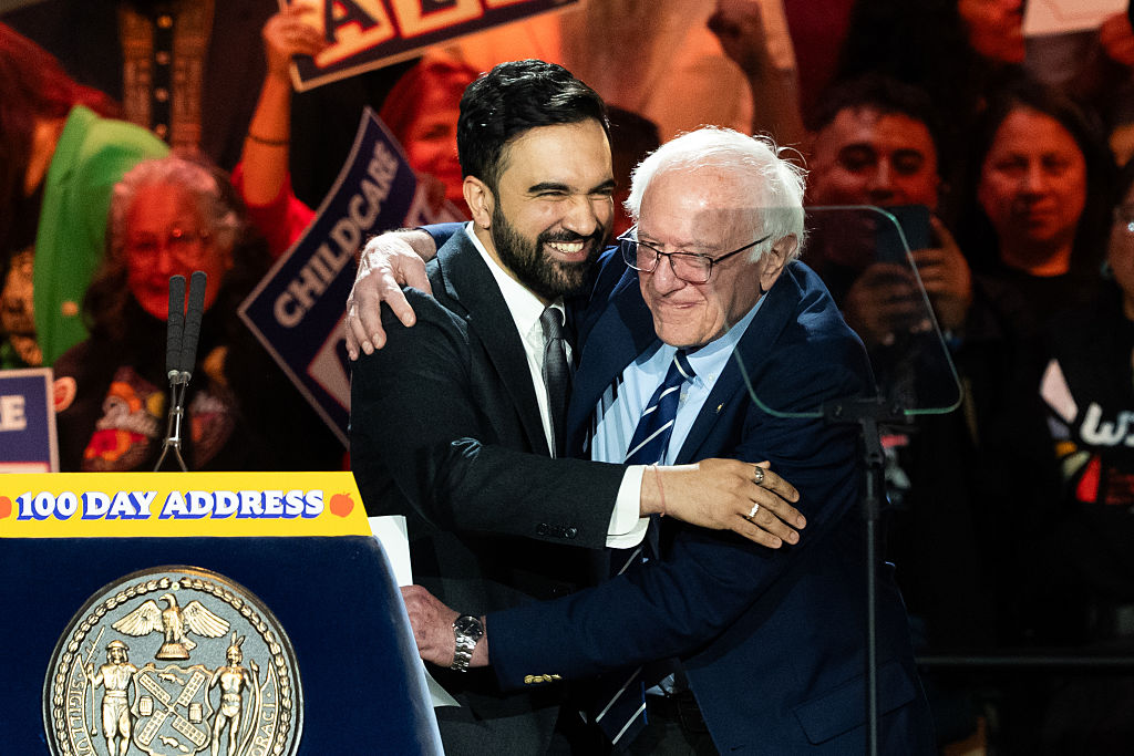 Zohran Mamdani and Bernie Sandersembrace during a One Hundred Days rally in the Queens borough of New York, on April 12, 2026.