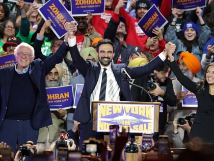 Then New York City mayoral candidate Zohran Mamdani holds hands with US Senator Bernie Sanders (I-VT) and US Representative Alexandria Ocasio-Cortez (D-NY) at the end of a campaign rally at Forest Hills Stadium in the Queens borough of New York City on October 26, 2025.