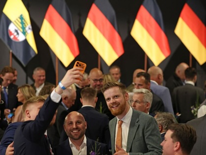 AfD supporters at an election watch party Magdeburg, Germany, do a selfie just before initial results showed the party with 44 percent of the vote in Saxony-Anhalt state elections on September 6, 2026.
