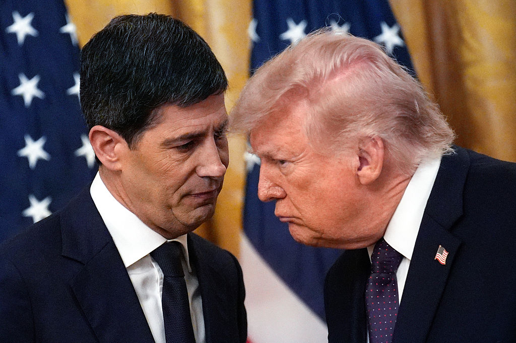 Donald Trump speaks with Kevin Warsh at the White House.