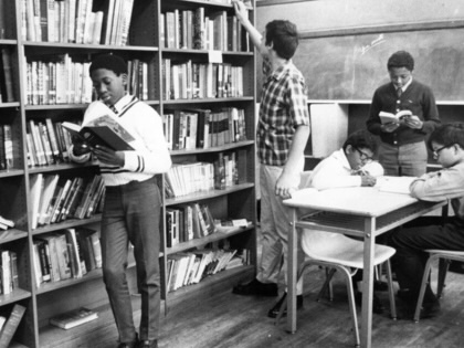 Teenage students work at a library, circa 1965.