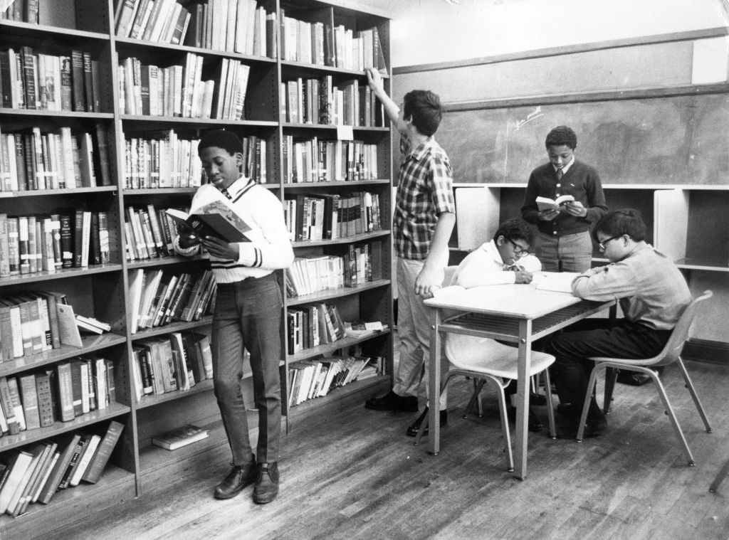 Teenage students work at a library, circa 1965.